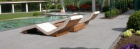Pool Design. Outdoor pool - Floor in Natural Stone Basalt – Loungers carved out from a Limestone block.jpg